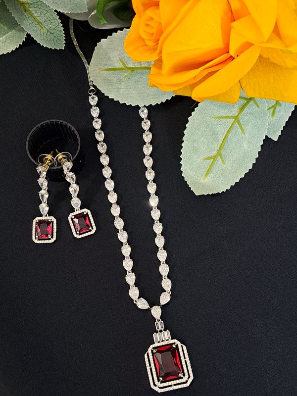 silver color pendant with red square stone